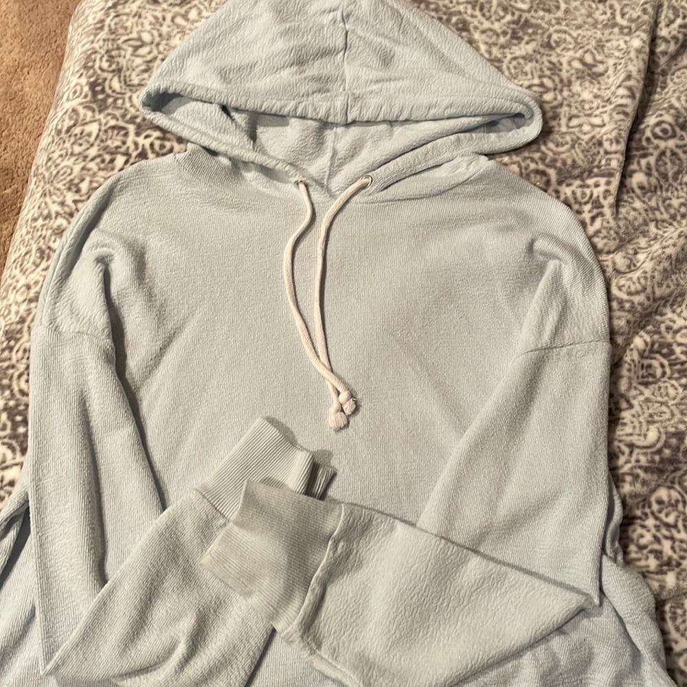 XL light blue cropped long sleeve shirt with hood.
